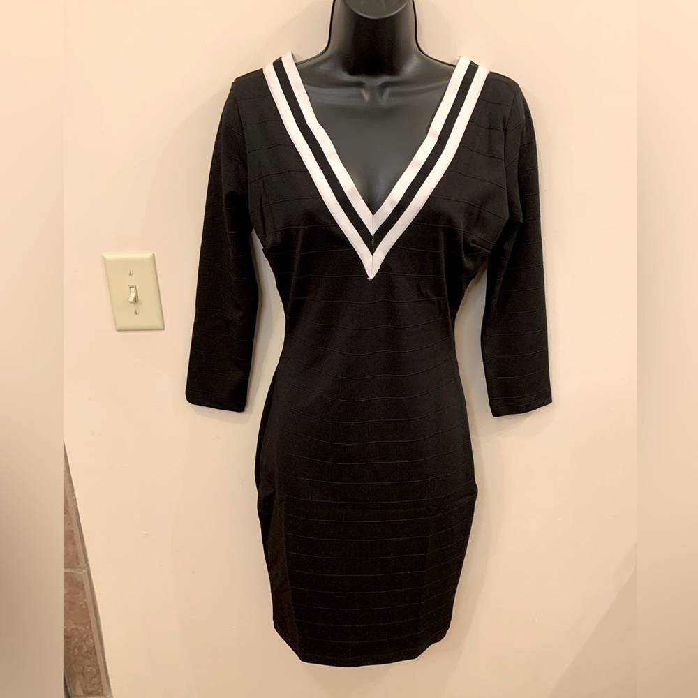 Symphony fitted black v-neck dress with cream and black banding. Size M.